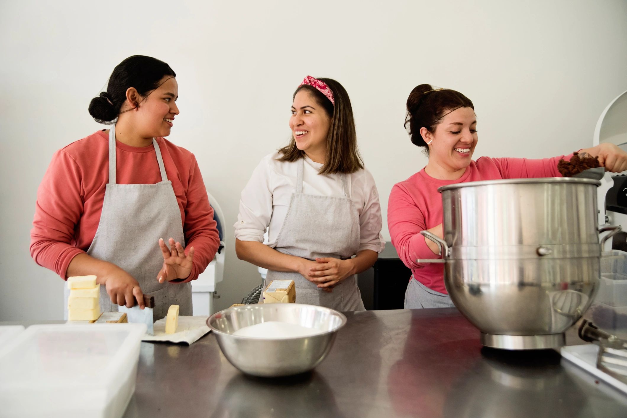 Bakery shop owner with staff in a small local bakery
