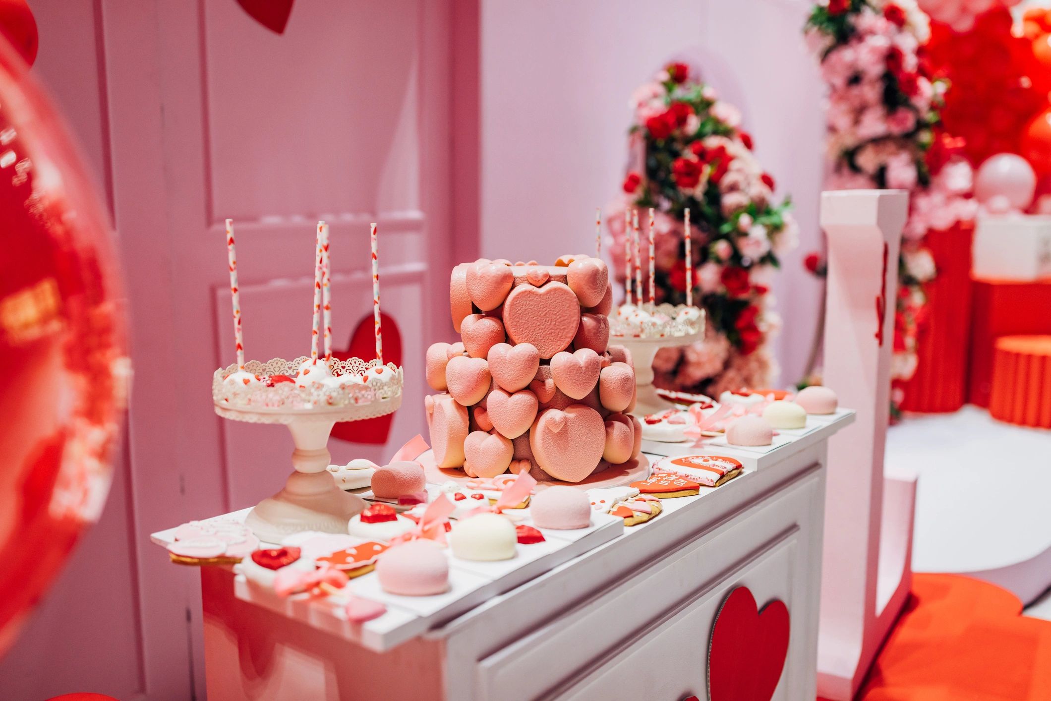 Sweet table with cakes and heart-shaped sweets