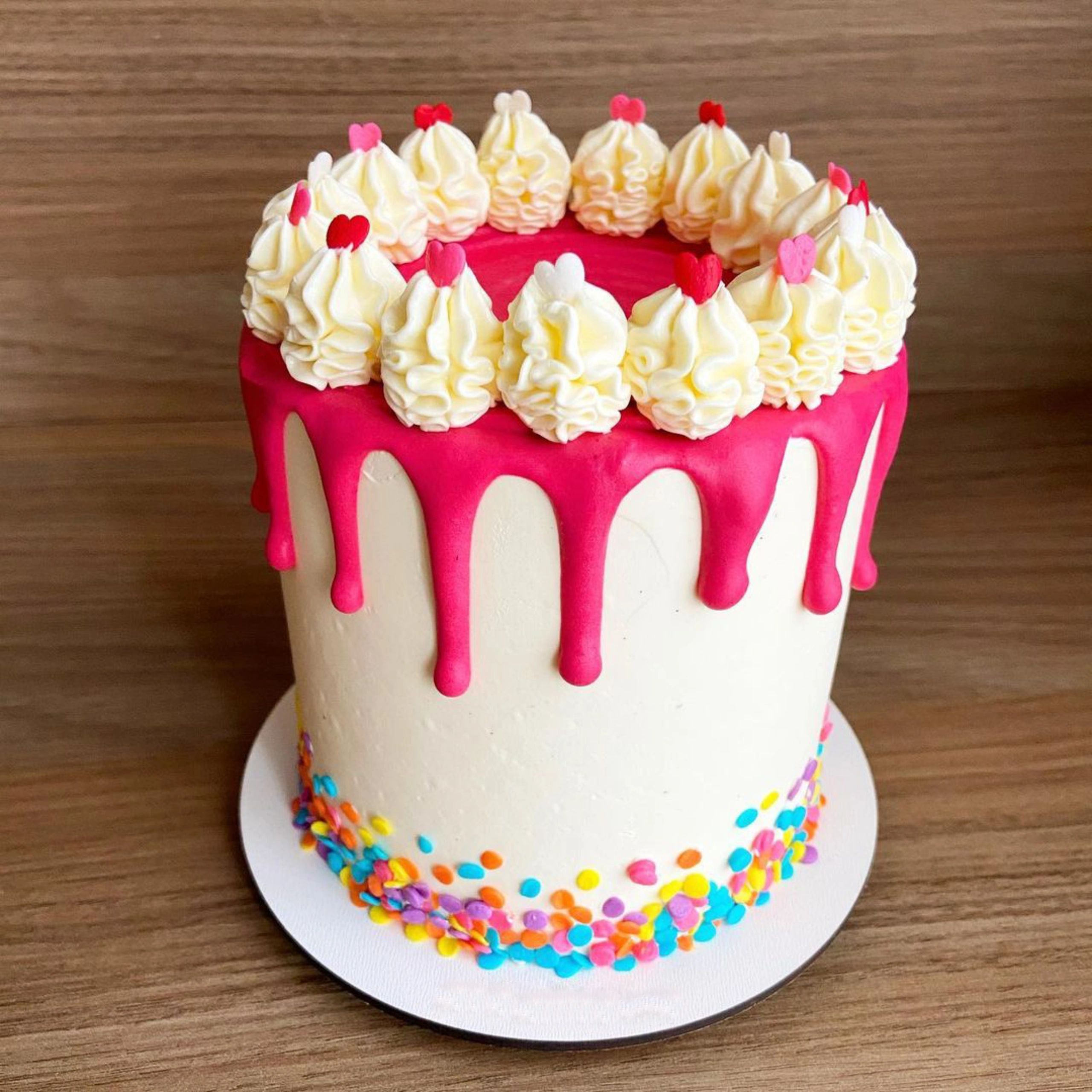 Drip cake with colorful confetti sprinkles