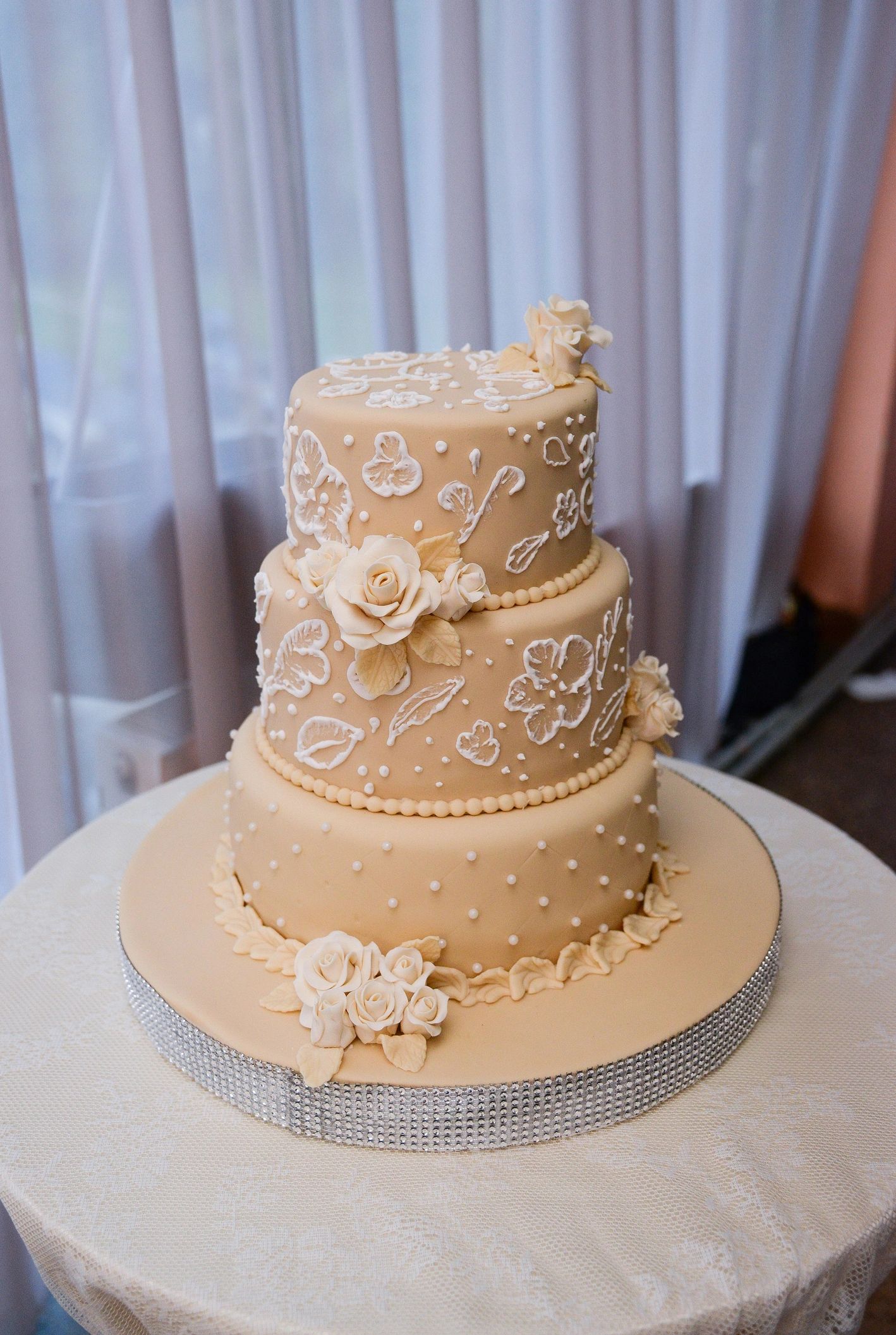 Three-tier wedding cake with floral decorations