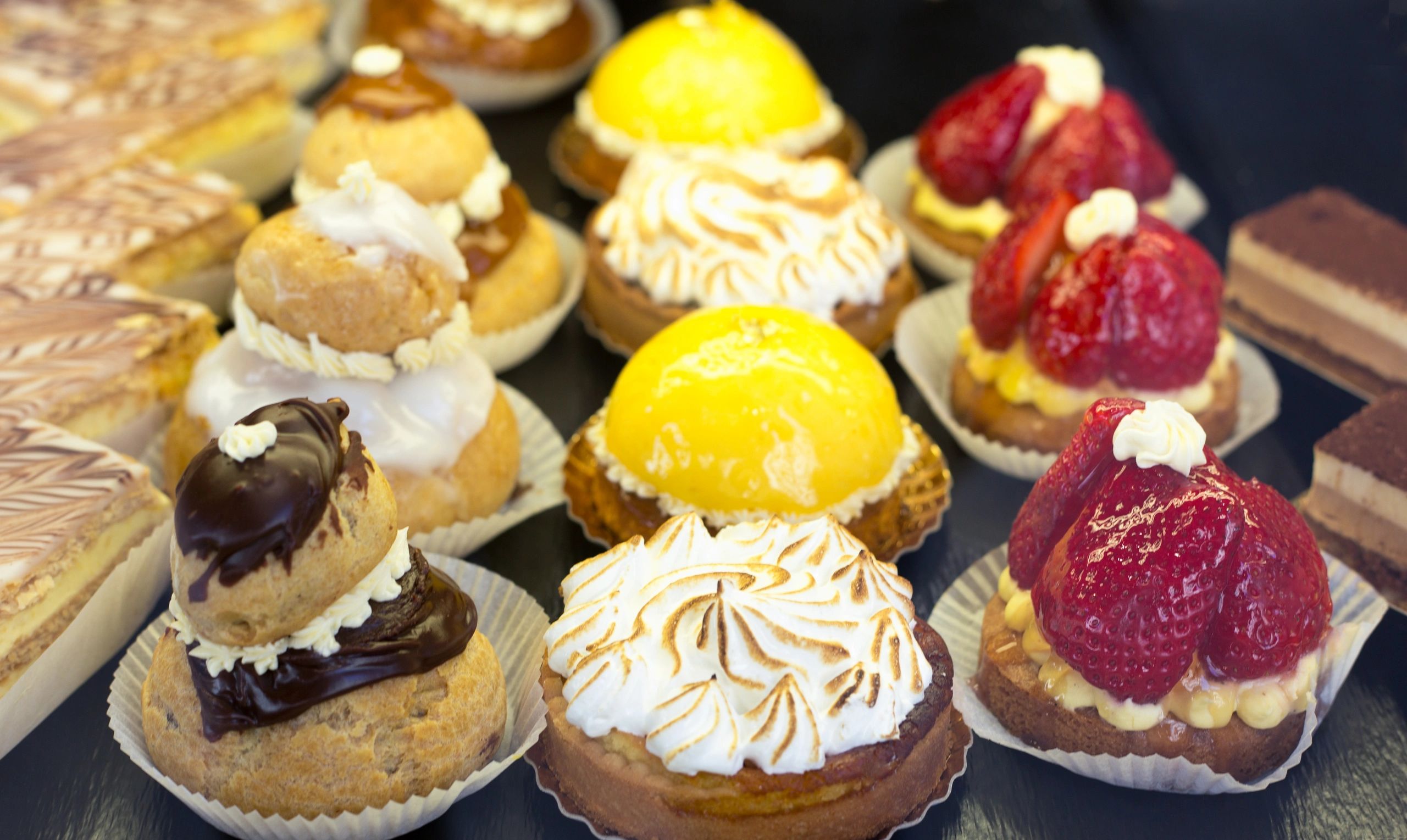 Fancy pastries in a bakery window close-up