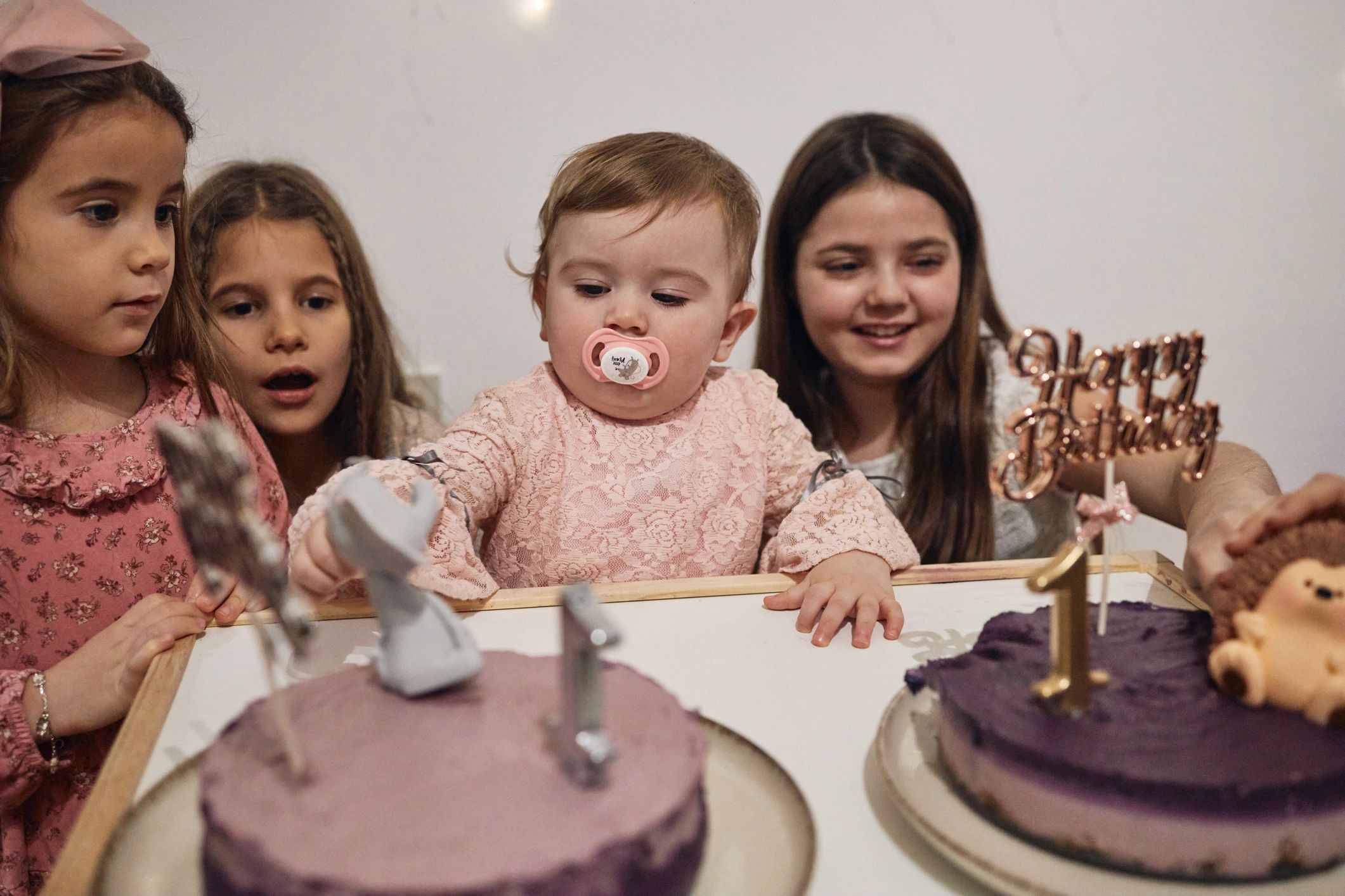 Children enjoying cake at a first birthday party